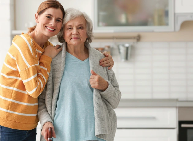 caregiver and senior adult in close embrace